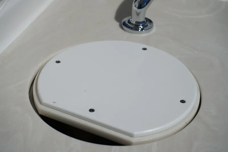 Slide: The Image of 2025 Edgewater 248 CX boat interior with sink and cup holders. - 16