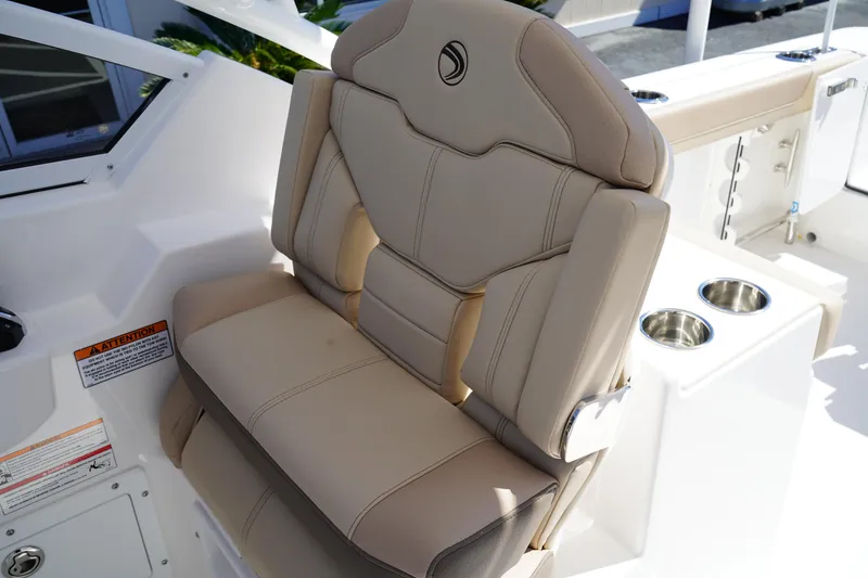 Slide: The Image of Interior cabin view of 2025 Edgewater 248 CX boat, featuring a small porthole window. - 25