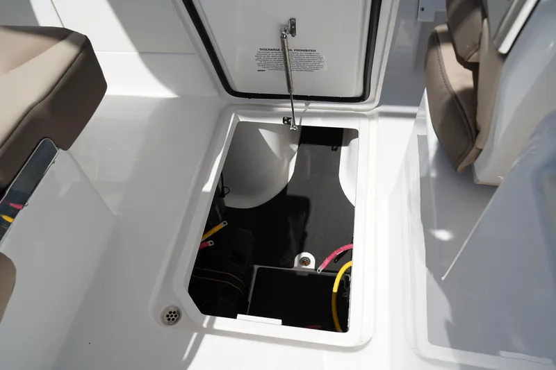 Slide: The Image of 2025 Edgewater 248 CX boat interior with storage compartment and seating. - 31