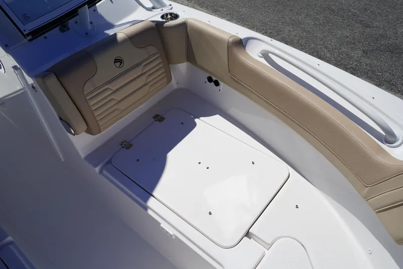 Slide: The Image of 2025 Edgewater 248 CX boat storage compartment with open hatch and visible wiring. - 32