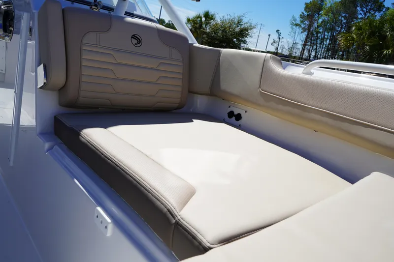 Slide: The Image of Luxurious seating on 2025 Edgewater 248 CX boat, featuring beige cushions and sleek design. - 35