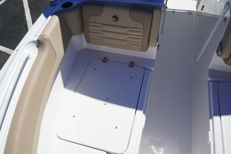 Slide: The Image of 2025 Edgewater 248 CX boat interior with beige cushioned seating. - 38