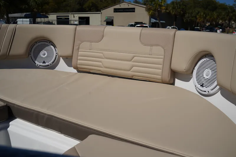 Slide: The Image of 2025 Edgewater 248 CX boat interior with beige seating and built-in speakers. - 41