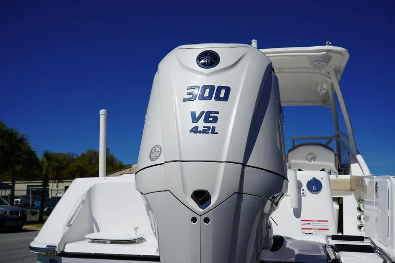 Slide: The Image of 2025 Edgewater 248 CX boat on trailer, featuring sleek design and Yamaha outboard motor. - 6