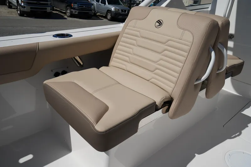 Slide: The Image of 2025 Edgewater 248 CX boat seat with beige and gray upholstery. - 9