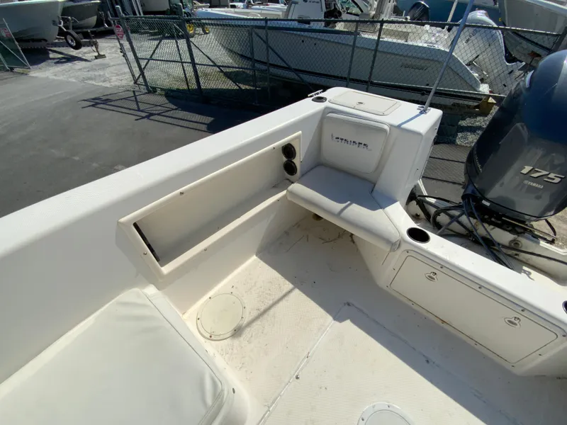 Slide: The Image of 1997 Seaswirl Striper 2100 DC boat interior with seating and storage compartments. - 13