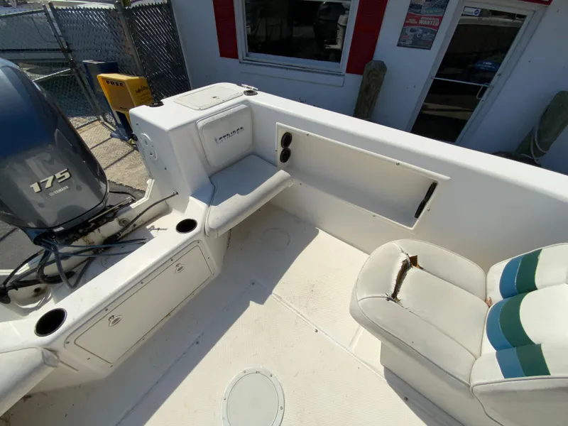 Slide: The Image of 1997 Seaswirl Striper 2100 DC boat interior with seating and 175 HP engine. - 14