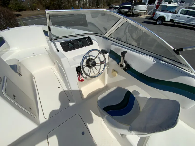 Slide: The Image of 1997 Seaswirl Striper 2100 DC boat interior with steering wheel and seating. - 16