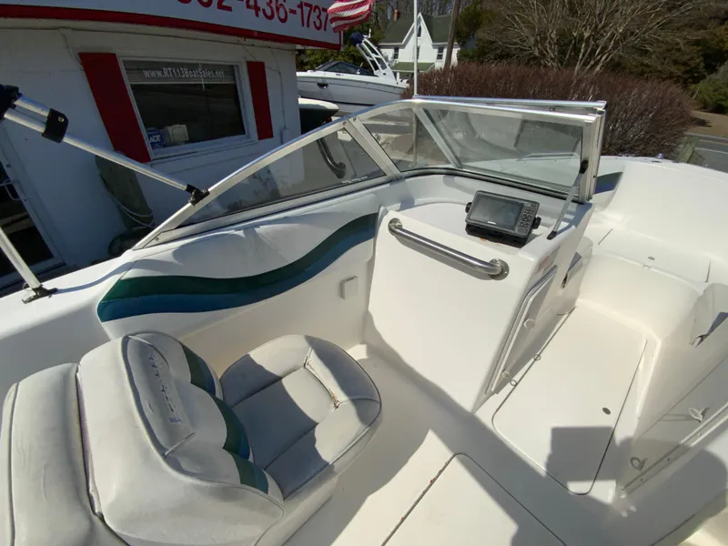 Slide: The Image of 1997 Seaswirl Striper 2100 DC boat interior with seating and dashboard view. - 17