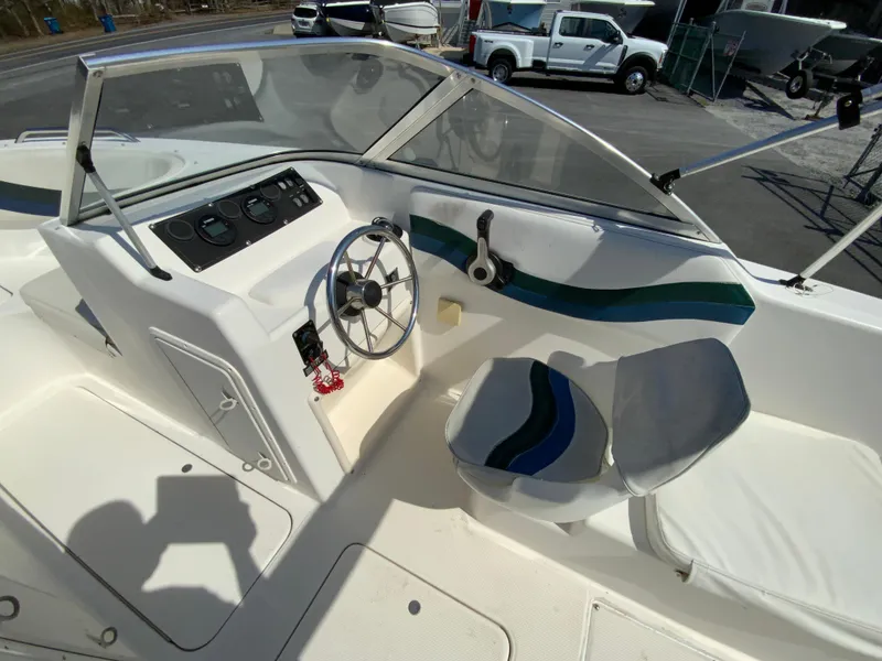 Slide: The Image of 1997 Seaswirl Striper 2100 DC boat interior with steering wheel and seating. - 19