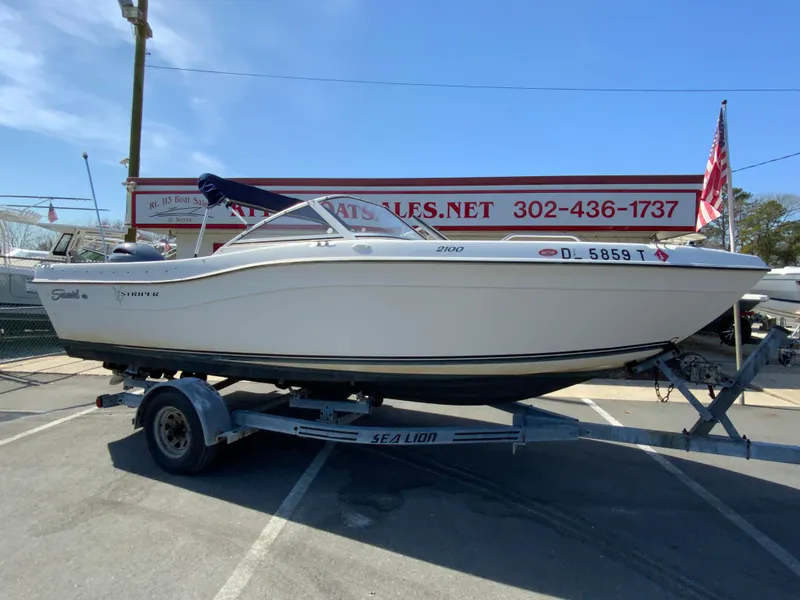 Slide: The Image of 1997 Seaswirl Striper 2100 DC boat on trailer at dealership, side view. - 2