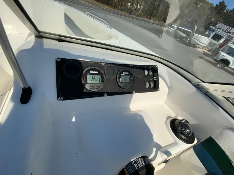 Slide: The Image of 1997 Seaswirl Striper 2100 DC dashboard with Yamaha gauges and controls. - 21