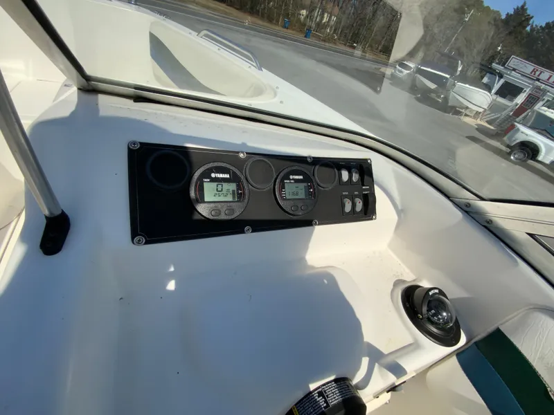 Slide: The Image of 1997 Seaswirl Striper 2100 DC dashboard with gauges and controls in sunlight. - 22