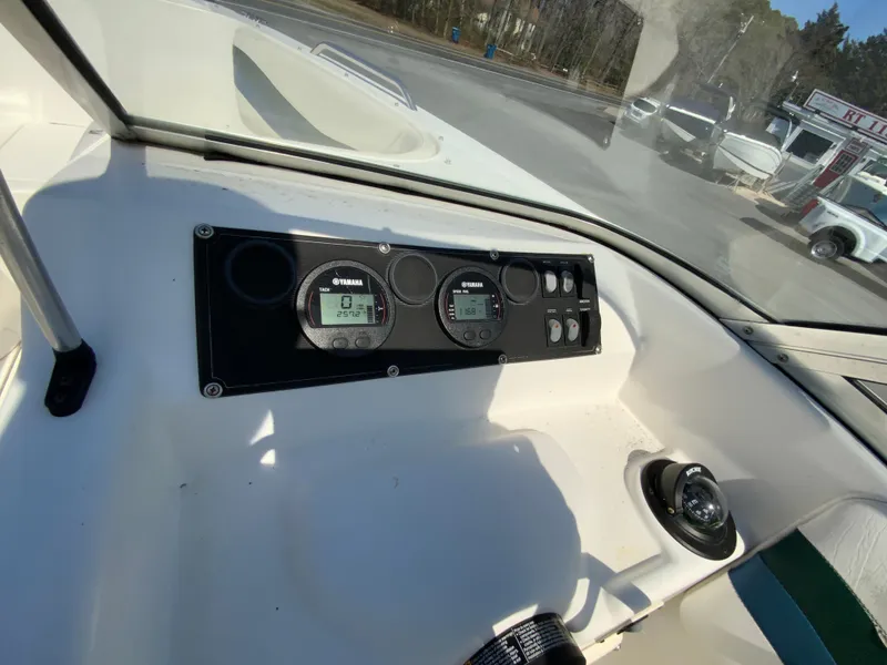 Slide: The Image of 1997 Seaswirl Striper 2100 DC dashboard with Yamaha gauges and controls. - 23