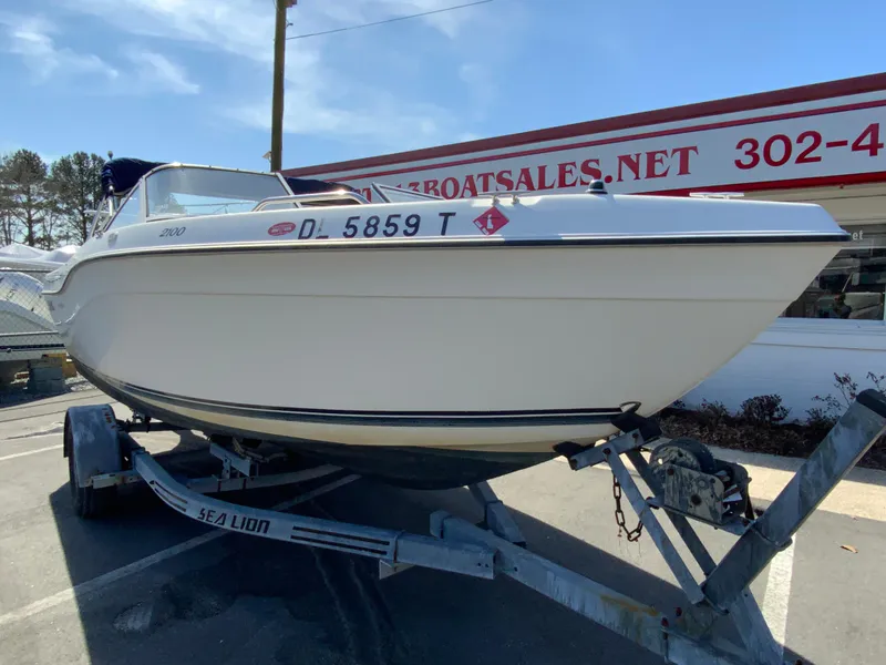 Slide: The Image of 1997 Seaswirl Striper 2100 DC boat on trailer at dealership. - 3