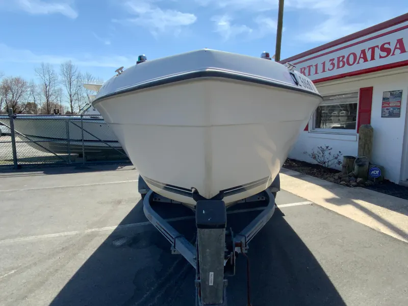 Slide: The Image of 1997 Seaswirl Striper 2100 DC boat on trailer, parked outside a dealership. - 4