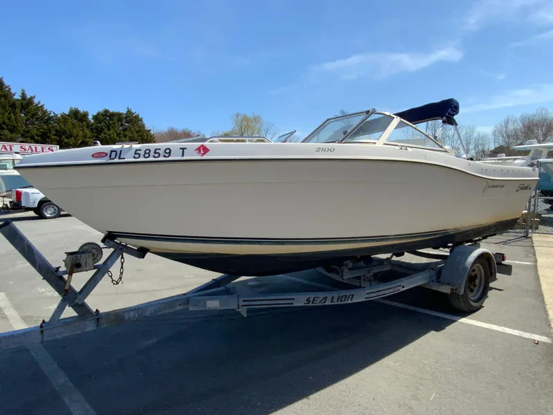 Slide: The Image of 1997 Seaswirl Striper 2100 DC boat on trailer in parking lot. - 5