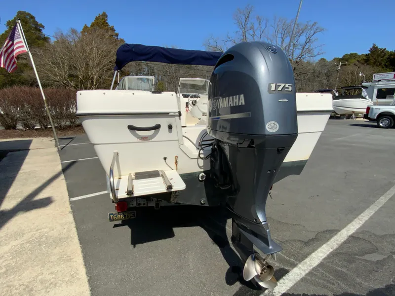 Slide: The Image of 1997 Seaswirl Striper 2100 DC boat with Yamaha 175 outboard motor, parked outdoors. - 7