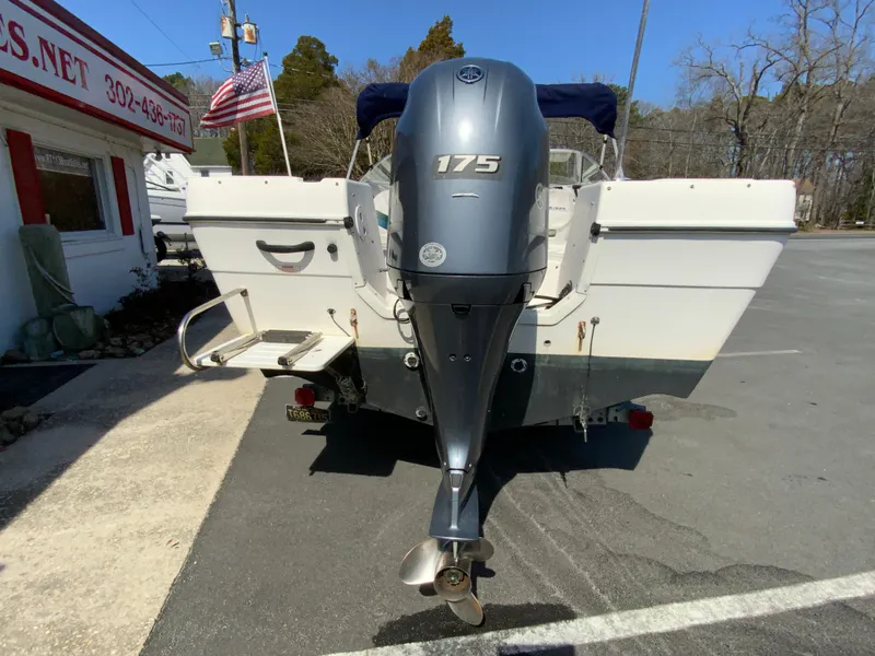 Slide: The Image of 1997 Seaswirl Striper 2100 DC boat with 175 HP outboard motor, parked outdoors. - 8