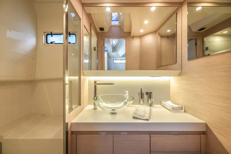 Slide: The Image of Luxurious yacht bathroom with modern glass sink, elegant lighting, and wooden cabinetry, Solaris Power 2022. - 18
