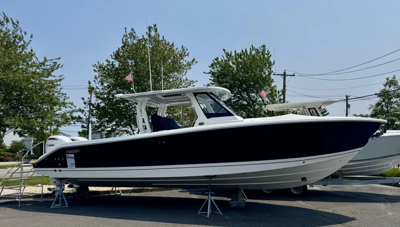 The Image of 2025 Pursuit S 328 boat displayed outdoors on stands. - 0