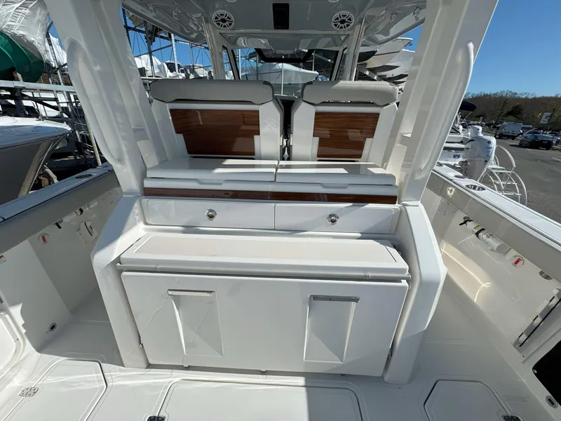 Slide: The Image of 2025 Pursuit S 328 boat interior with seating and storage compartments. - 13