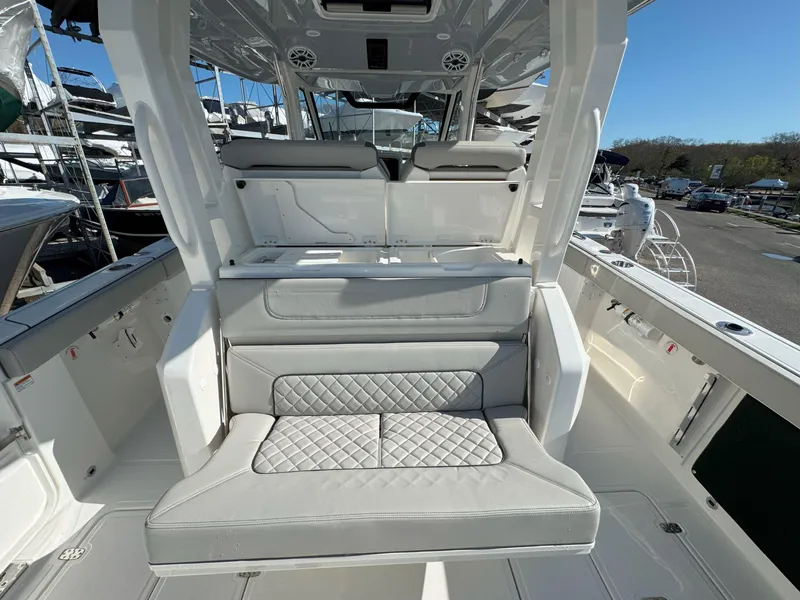 Slide: The Image of 2025 Pursuit S 328 boat interior with cushioned seating and sleek design. - 14