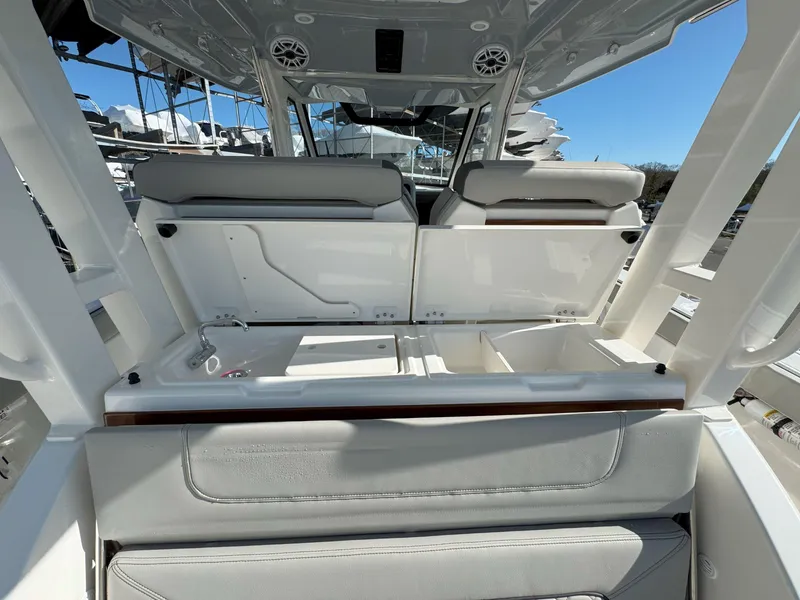 Slide: The Image of 2025 Pursuit S 328 boat interior with open storage compartments and seating. - 15