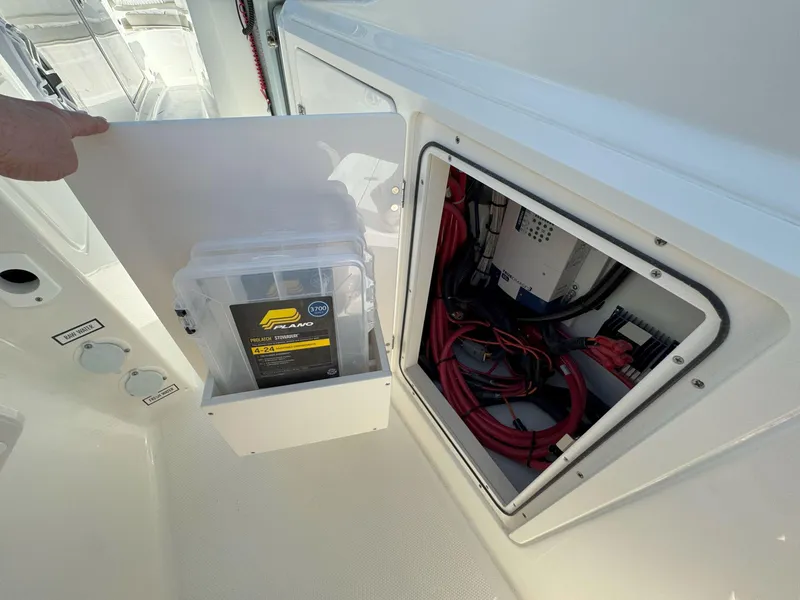 Slide: The Image of 2025 Pursuit S 328 boat storage compartments with electrical wiring and equipment. - 18