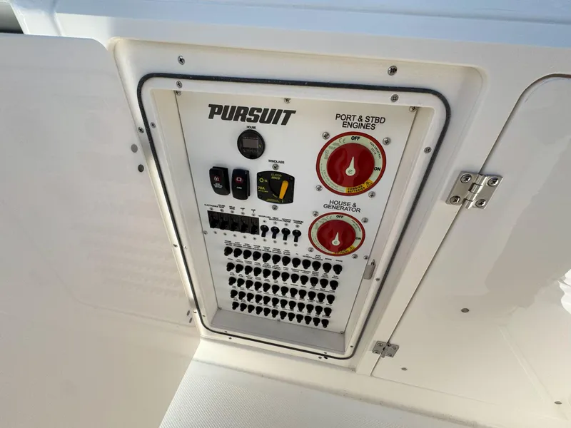 Slide: The Image of Control panel of 2025 Pursuit S 328 boat with engine and generator switches. - 19