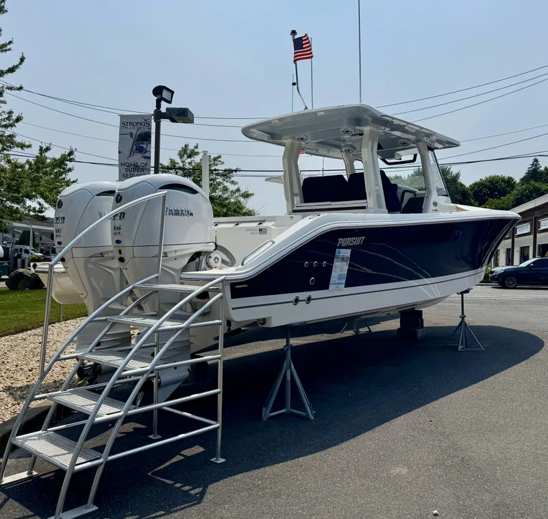 Slide: The Image of 2025 Pursuit S 328 boat displayed on stands with American flag in background. - 3