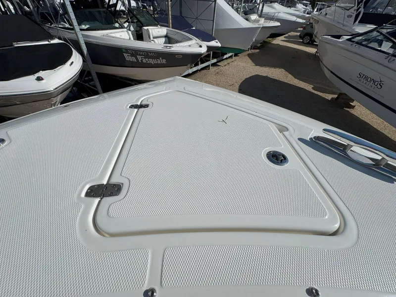 Slide: The Image of 2025 Pursuit S 328 boat deck, featuring a sleek, textured surface in a marina setting. - 34