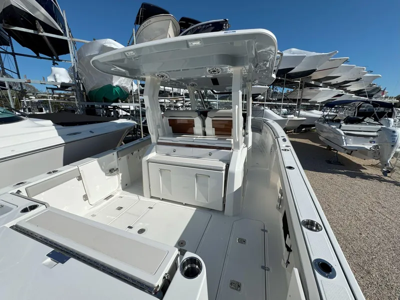 Slide: The Image of 2025 Pursuit S 328 boat with spacious deck and modern design, displayed outdoors. - 7