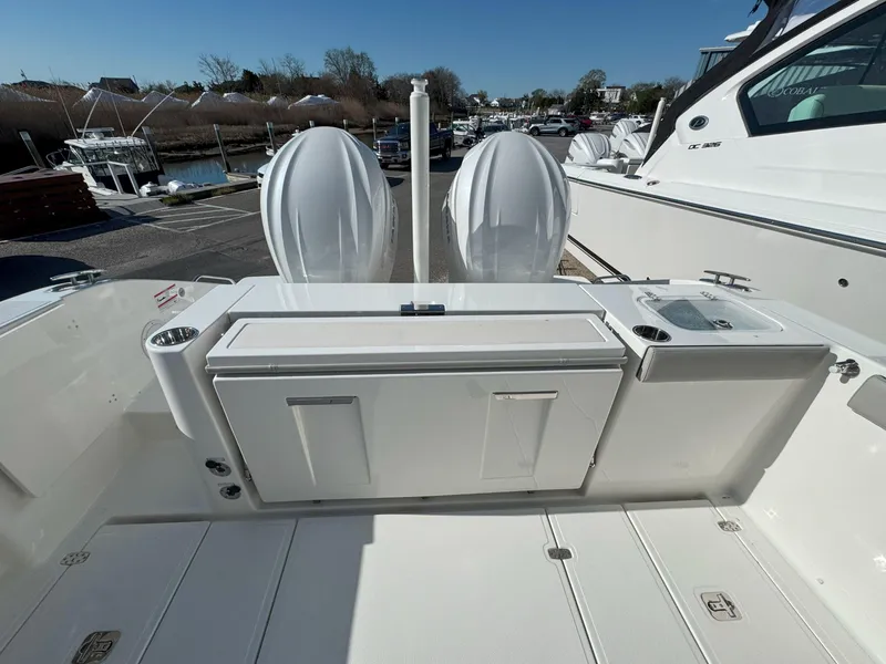 Slide: The Image of 2025 Pursuit S 328 boat deck with dual engines and storage compartments. - 9
