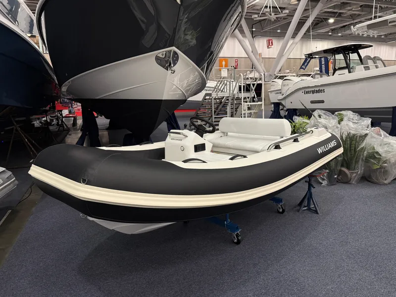 Slide: The Image of 2024 Williams Jet Tenders Sportjet 345 displayed indoors at a boat show. - 2