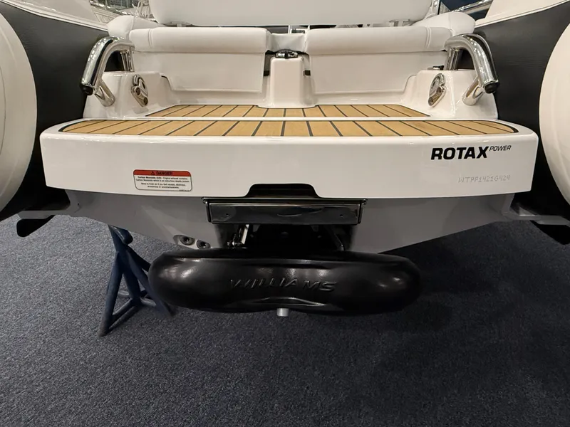 Slide: The Image of 2024 Williams Jet Tenders Sportjet 345 rear view, featuring Rotax engine and teak deck. - 6