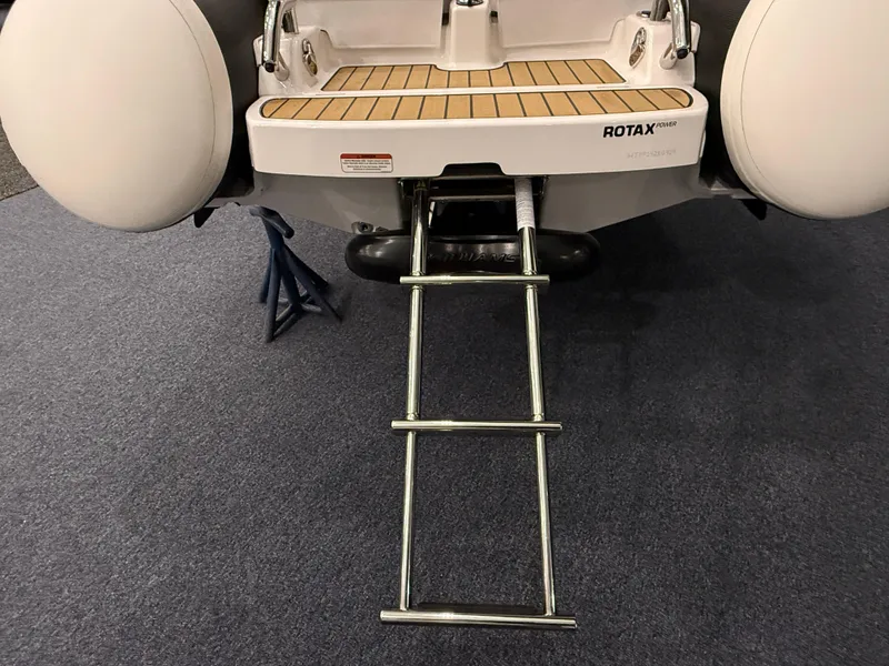 Slide: The Image of 2024 Williams Jet Tenders Sportjet 345 with ladder and Rotax engine, rear view. - 7