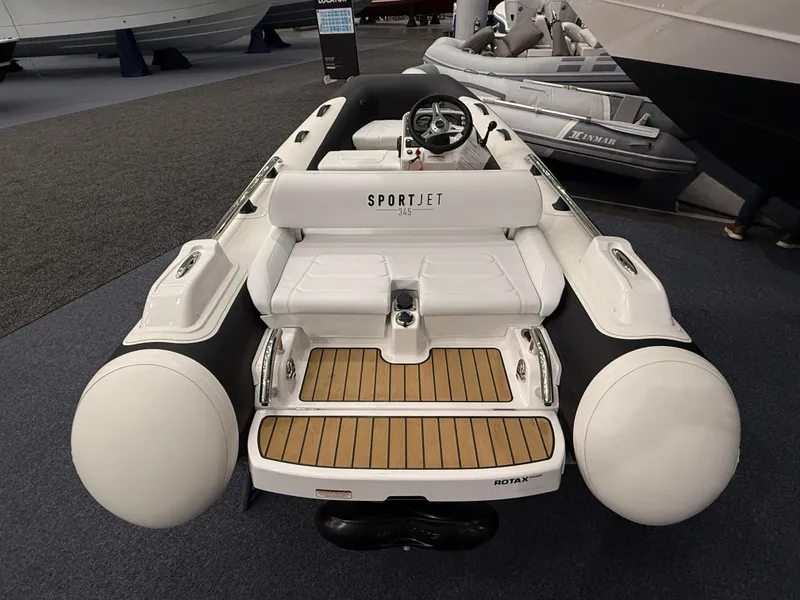Slide: The Image of 2024 Williams Jet Tenders Sportjet 345, white inflatable boat with wooden deck, rear view. - 8