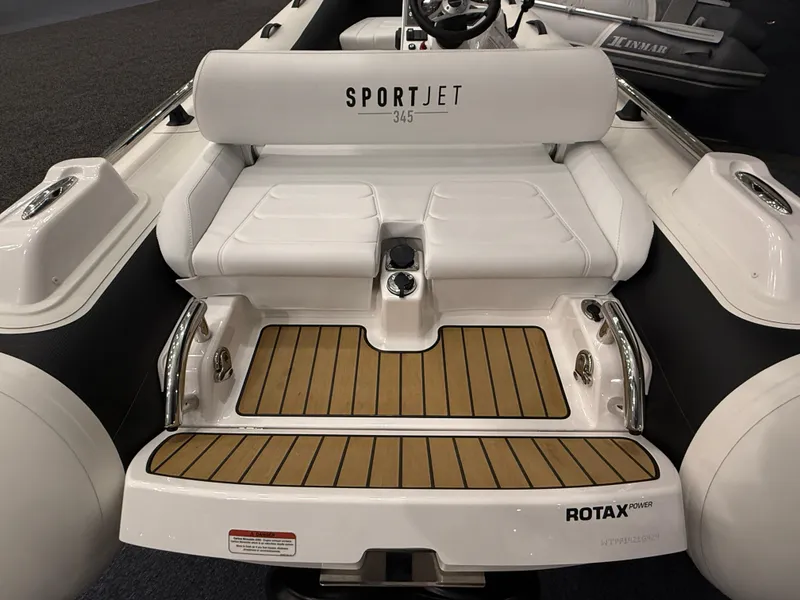 Slide: The Image of 2024 Williams Jet Tenders Sportjet 345, rear view with seating and Rotax engine. - 9