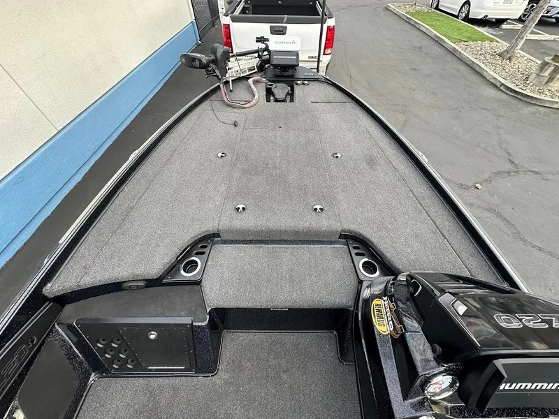 Slide: The Image of 2021 Nitro Z20 Pro boat deck with trolling motor, parked near a white truck. - 18