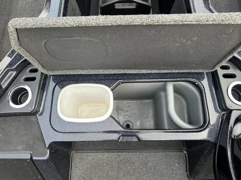 Slide: The Image of 2021 Nitro Z20 Pro boat storage compartment with cup holders and open lid. - 27