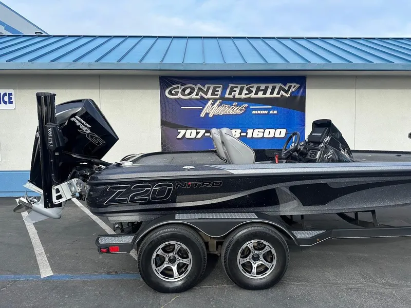 Slide: The Image of Nitro Z20 Pro 2021 boat on trailer, parked outside dealership with "Gone Fishin'" sign. - 6