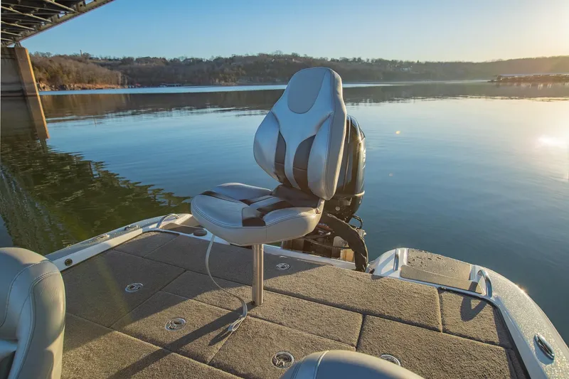 Slide: The Image of Phoenix 618 Pro 2017 boat seat on calm lake under bridge at sunset. - 14