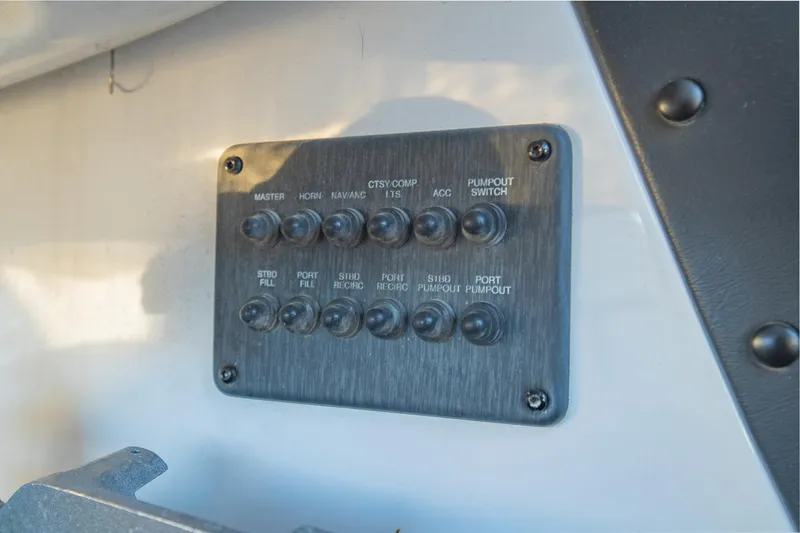Slide: The Image of Control panel on a 2017 Phoenix 618 Pro boat with labeled switches. - 18