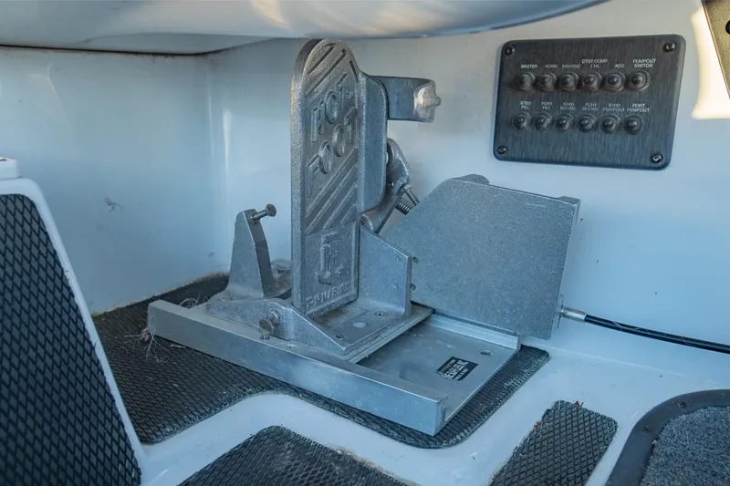 Slide: The Image of Control panel and foot pedal in a 2017 Phoenix 618 Pro boat cockpit. - 19