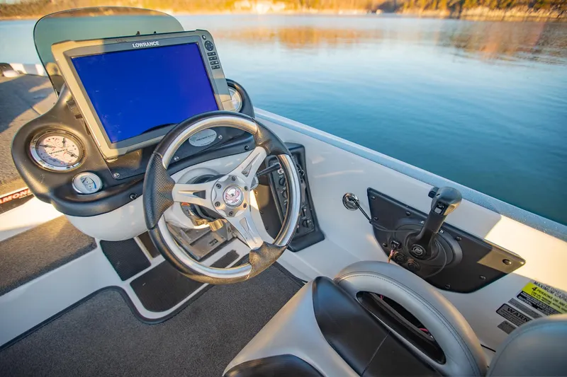 Slide: The Image of Cockpit of 2017 Phoenix 618 Pro boat with steering wheel and navigation system. - 23