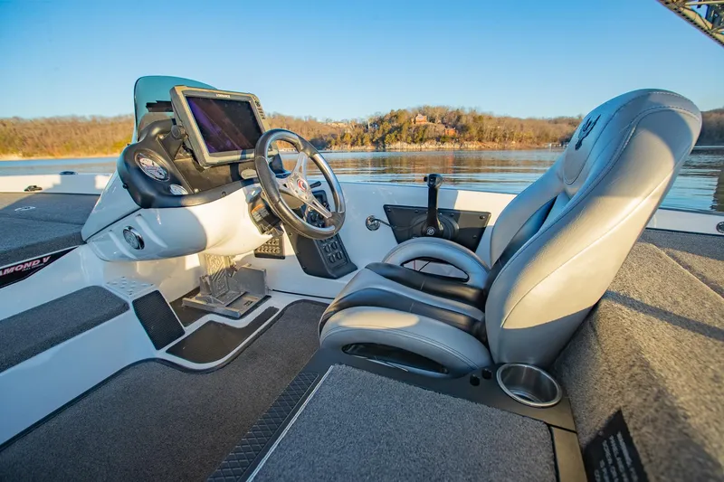 Slide: The Image of Interior of a 2017 Phoenix 618 Pro boat with steering wheel and seating. - 24