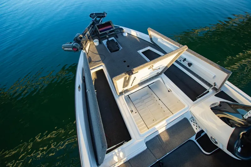 Slide: The Image of 2017 Phoenix 618 Pro boat with open storage compartments on calm water. - 26