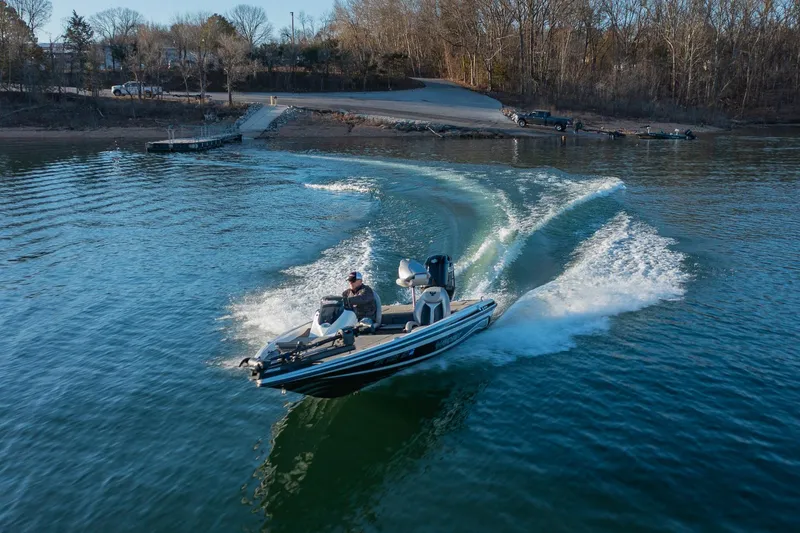 Slide: The Image of 2017 Phoenix 618 Pro boat speeding on a lake near a wooded shoreline. - 3