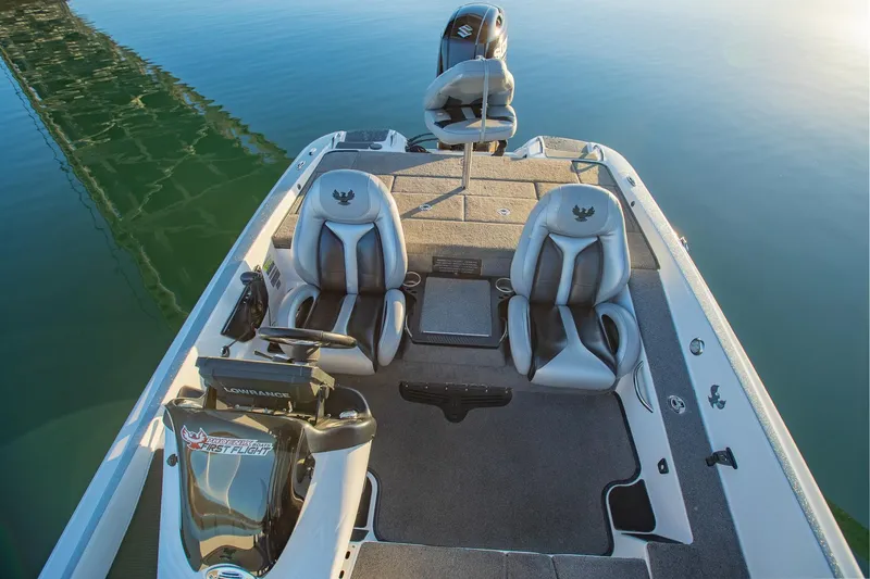 Slide: The Image of 2017 Phoenix 618 Pro boat interior with dual seats on calm water. - 5